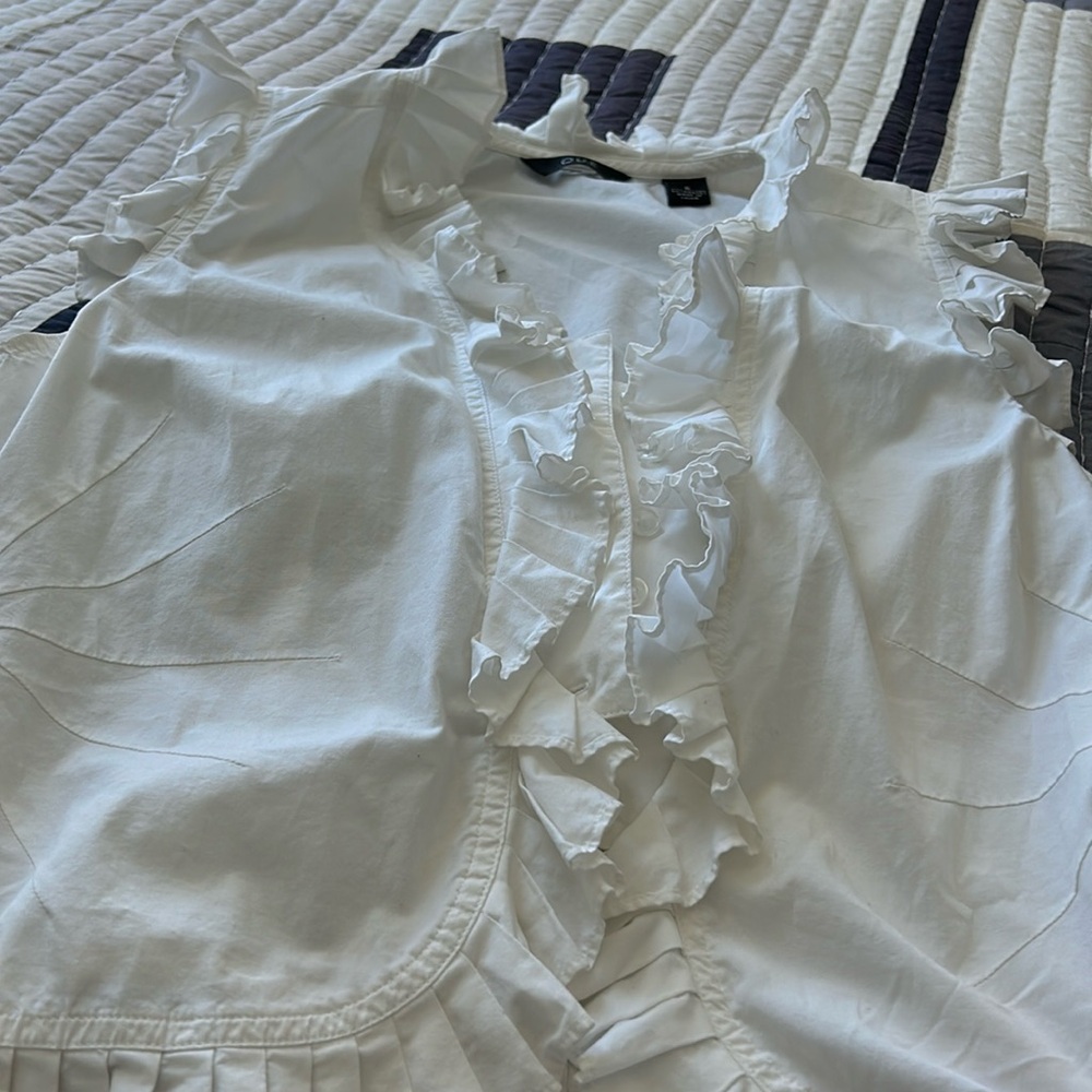 Ruffle white sleeveless top.